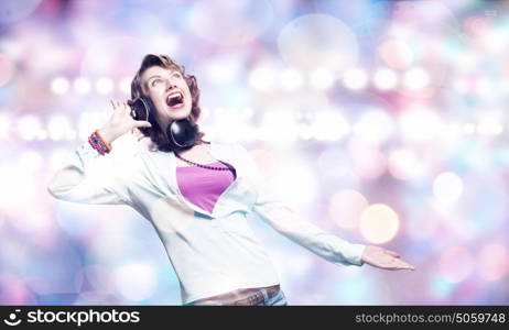 Music lover. Young pretty woman in casual wearing headphones