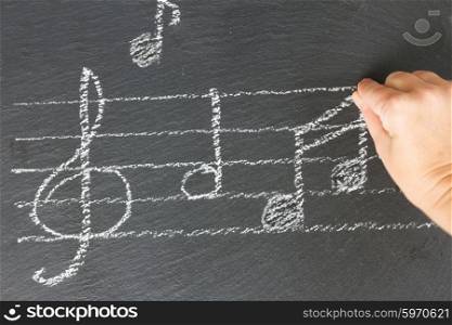 Music notes on black. Hand drawing music notes with treble clef