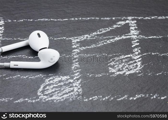 Music notes with headphones . Music notes with white headphones on black