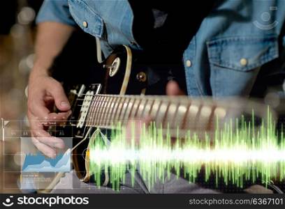 music, people, musical instruments and entertainment concept - close up of male guitarist playing electric guitar at studio rehearsal. close up of musician playing guitar at studio