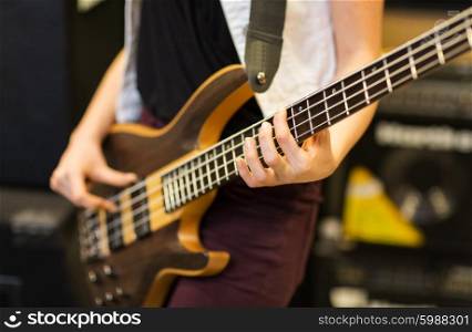music, people, musical instruments and entertainment concept - close up of musician with guitar at music studio