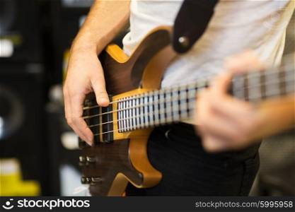 music, people, musical instruments and entertainment concept - close up of musician with guitar at music studio