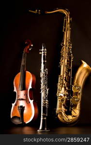 Music Sax tenor saxophone violin and clarinet in black background