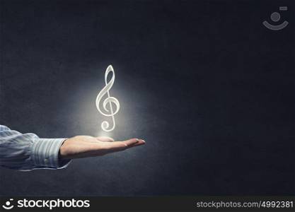 Music symbol. Close up of male hand giving note music