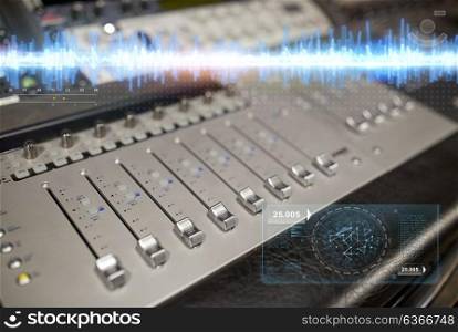music, technology, electronics and equipment concept - mixing console at sound recording studio. music mixing console at sound recording studio