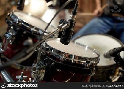 musical instruments and entertainment concept - drums and microphone at music studio. drums and microphone at music studio