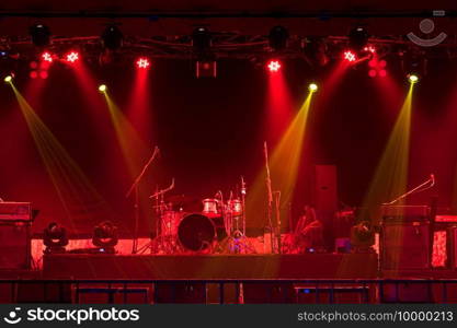 Musical instruments with spotlight on the stage with light ray  in conference hall or nightclub, party and celebrate, happy new year and merry Christmas concept, dump, guitar, microphone, 