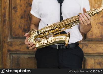 musician holding sax