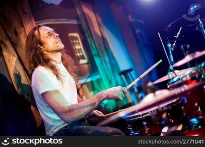 musician playing drums on a red background
