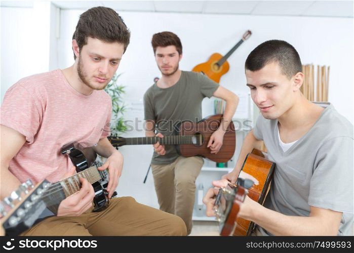 musicians with guitar at music store
