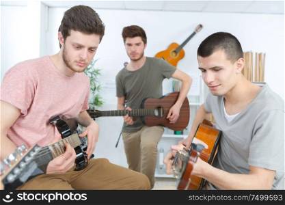 musicians with guitar at music store