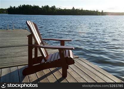 Muskoka chair on the dock overlooking the lake at Lake of the Woods, Ontario