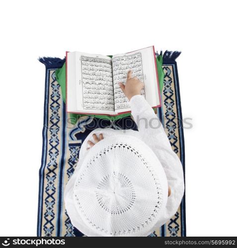 Muslim boy reading the Quran