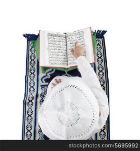 Muslim boy reading the Quran