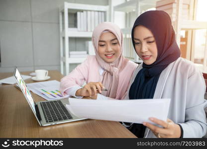 Muslim business woman in traditional clothing working and discussing at meeting in office