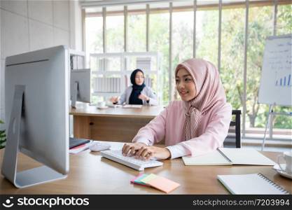 Muslim business woman in traditional clothing working and discussing at meeting in office