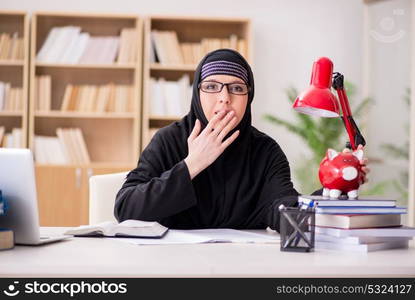 Muslim girl in hijab studying preparing for exams