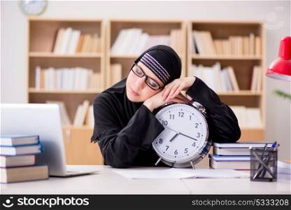Muslim girl in hijab studying preparing for exams