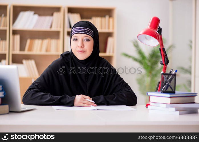 Muslim girl in hijab studying preparing for exams