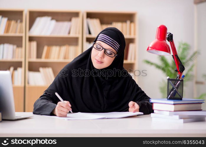 Muslim girl in hijab studying preparing for exams