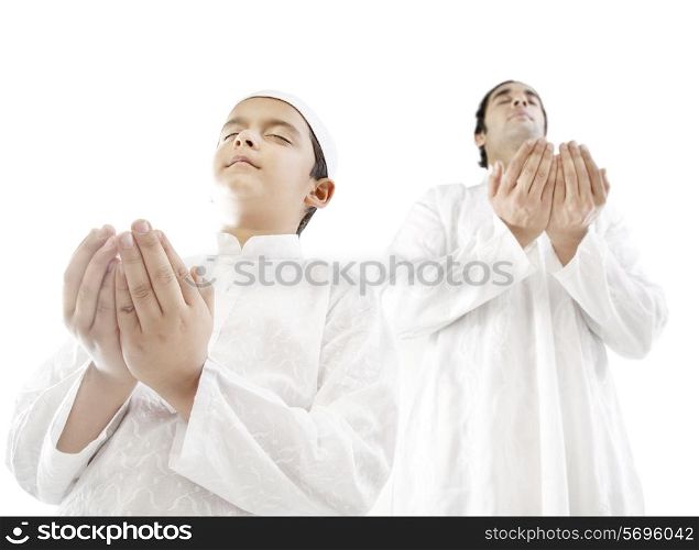 Muslim man and his son praying
