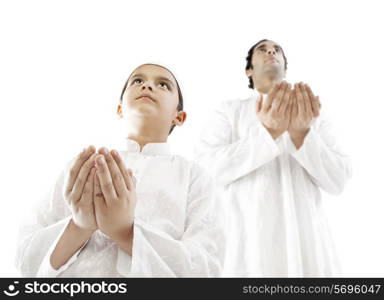 Muslim man and his son praying