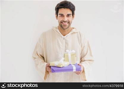 muslim man holding gift boxes