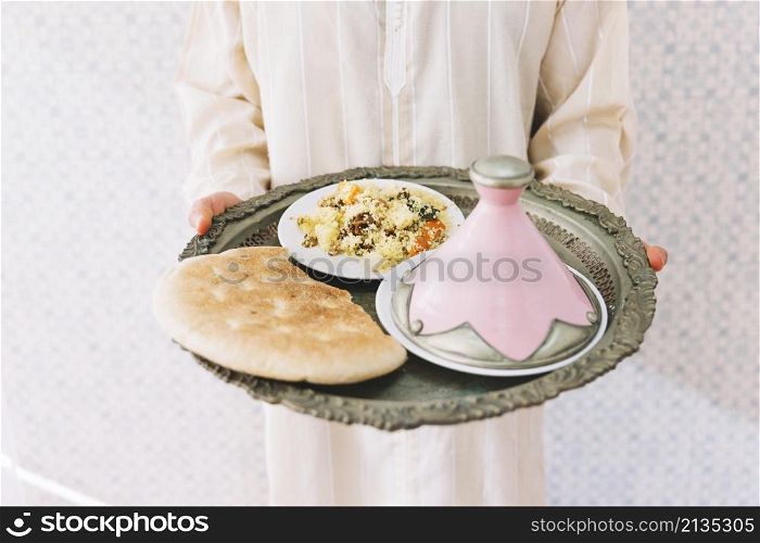 muslim man holding plate food