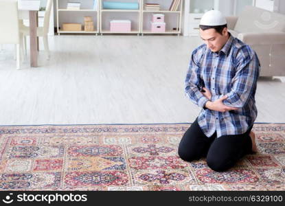 Muslim man praying at home