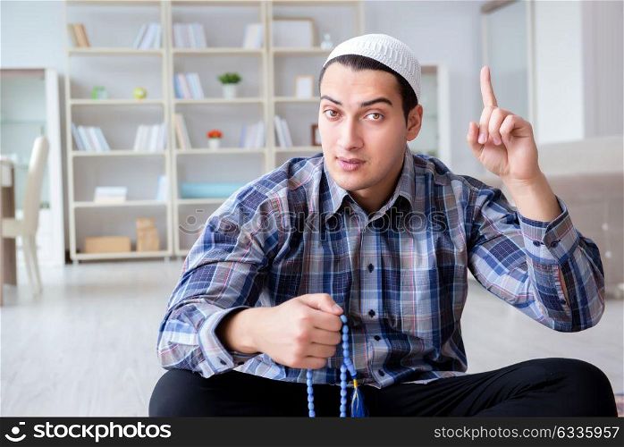 Muslim man praying at home