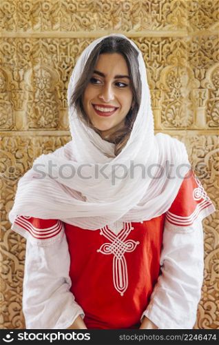 muslim woman front golden wall