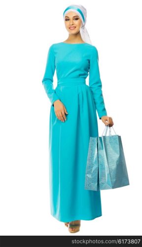 Muslim woman in blue dress with bags isolated