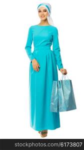 Muslim woman in blue dress with bags isolated