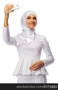 Muslim woman in white dress making selfie isolated
