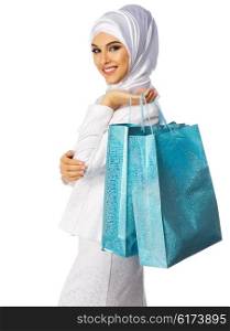 Muslim woman in white dress with bags isolated