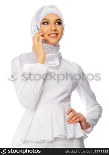 Muslim woman in white dress with mobile phone isolated