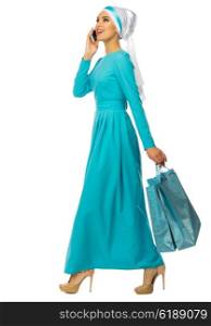 Muslim woman with mobile phone and bags isolated