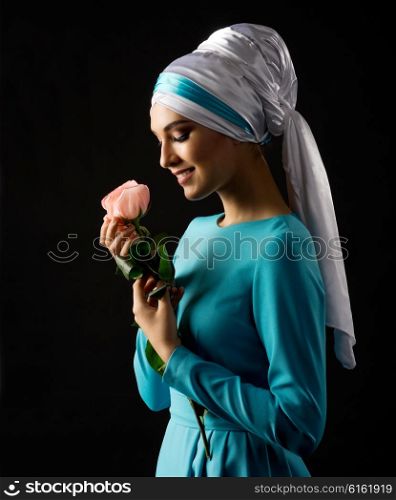 Muslim woman with rose on black
