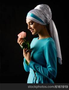 Muslim woman with rose on black