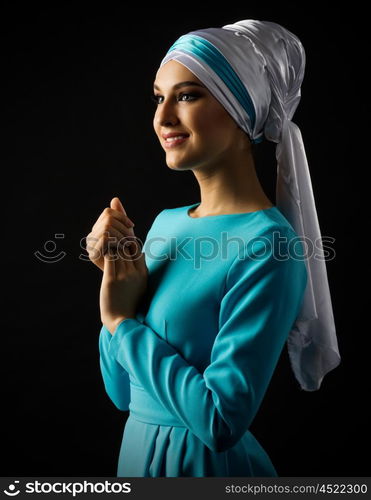 Muslim young girl on grey