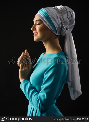 Muslim young woman on grey