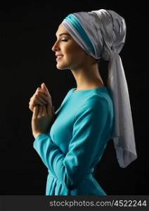 Muslim young woman on grey