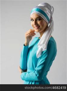 Muslim young woman on grey