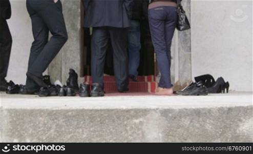 Muslims before entering the prayer hall take off their shoes