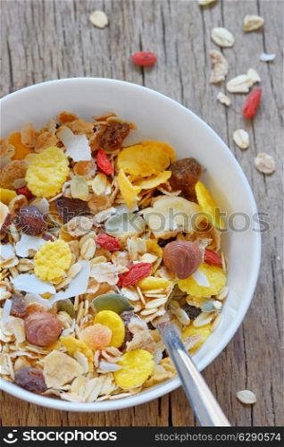 muslin cereal in a bowl on old wooden background