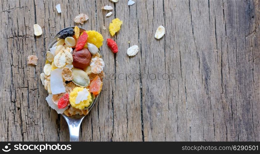 muslin cereal in a spoon on old wooden background