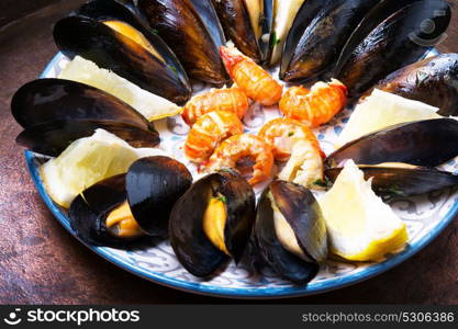 mussels with lemon. appetizer shellfish musselsin shell with lemon on retro background