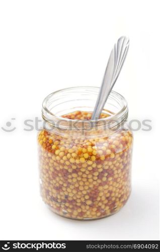 mustard dijon sauce in jar isolated on white background