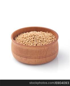 mustard seeds in wooden bowl isolated on white background
