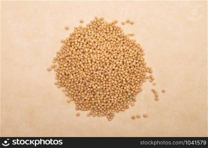 Mustard seeds on brown background